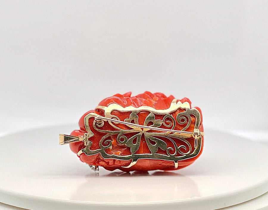 Gold carved oxblood coral diamond and emerald pendant brooch